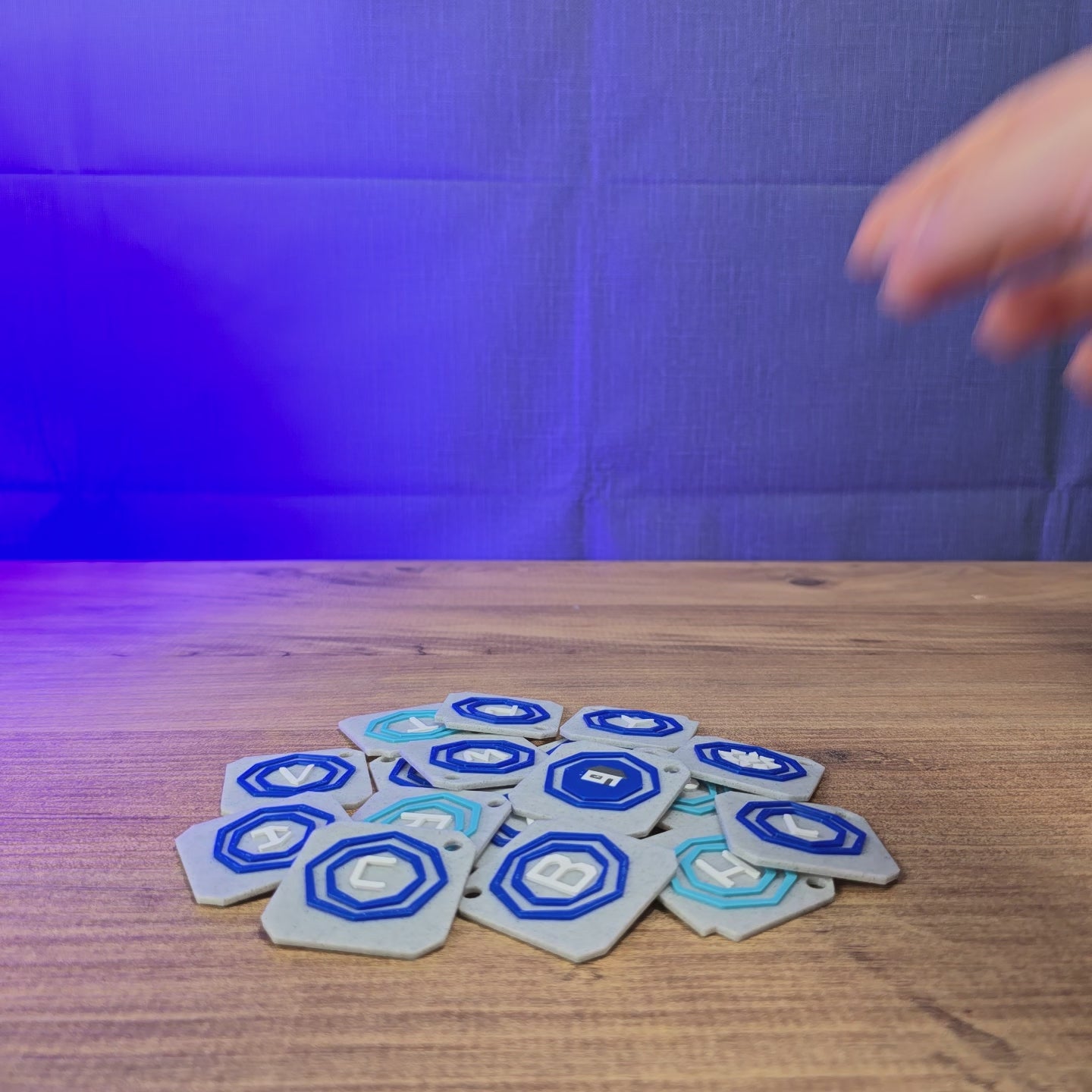 3D-printed Old School RuneScape teleport tablet keyring shown being held and rotated by hand, designed as an OSRS-inspired accessory for fans and players.