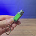 3D-printed Factorio nuclear keyring shown being held and rotated by hand, with a compact game-inspired design and keychain loop.