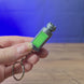 3D-printed Factorio nuclear keyring shown being held and rotated by hand, with a compact game-inspired design and keychain loop.