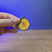 3D-printed Old School RuneScape Mark of Grace keyring shown being held and rotated by hand, designed as an OSRS-inspired gaming accessory.