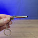 3D-printed 12GA double barrel shotgun keychain shown being held and rotated by hand, designed as a miniature shotgun-inspired accessory or keyring.