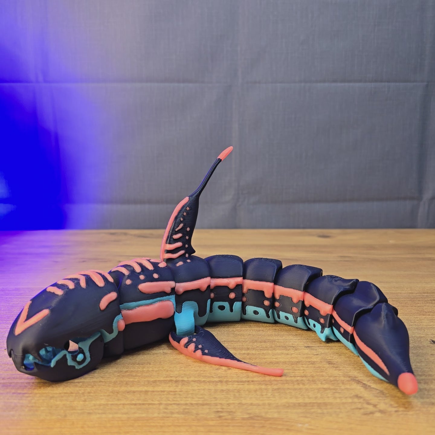 Hands display a Marrowbreach creature replica inspired by Subnautica 2, showing the shark-like predator design from multiple angles.