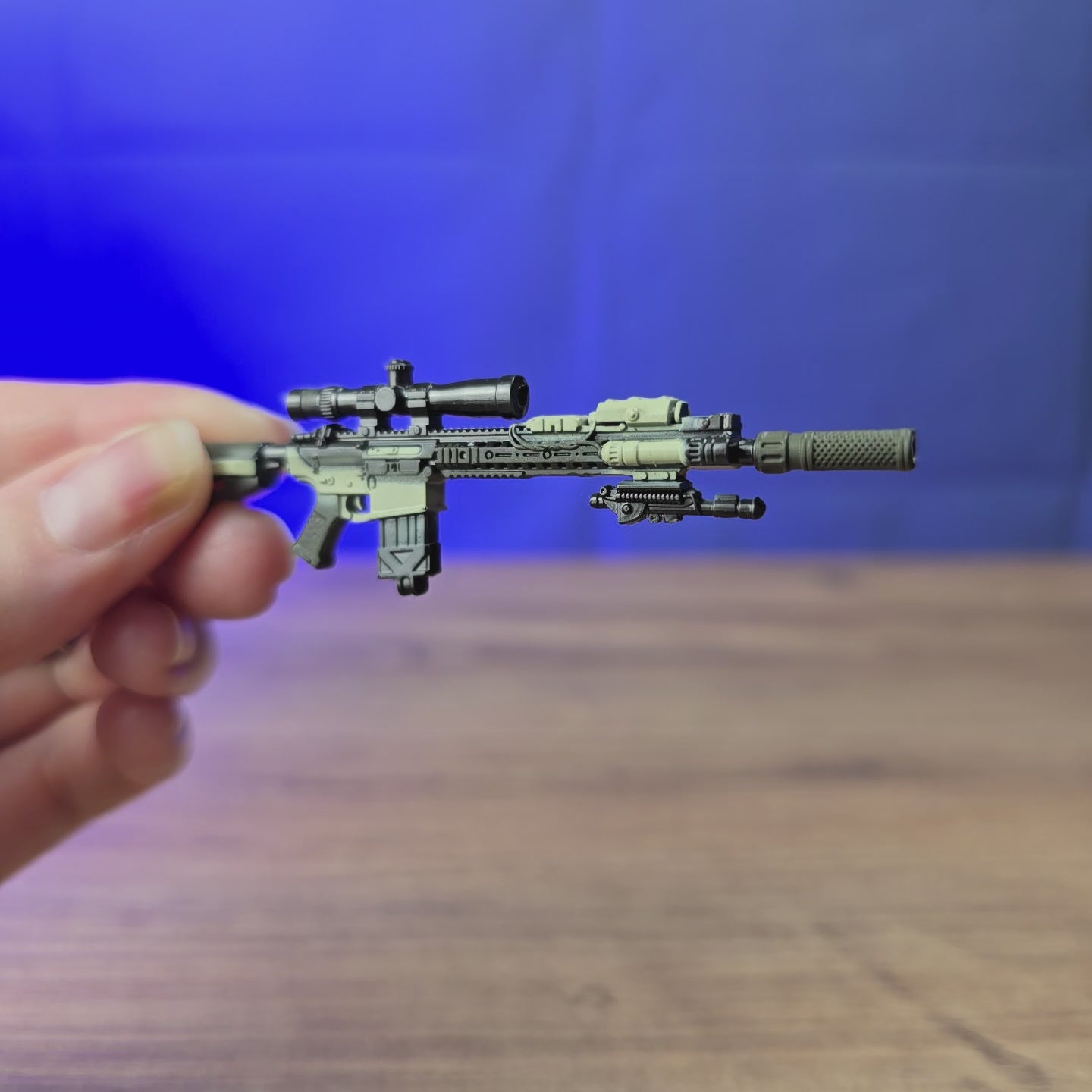 3D-printed SR25 DMR rifle keychain shown being held and rotated by hand, designed as a miniature rifle-inspired accessory or keyring.