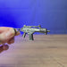 3D-printed HK G36 rifle keyring shown being held and rotated by hand, designed as a miniature rifle-inspired accessory or keychain.