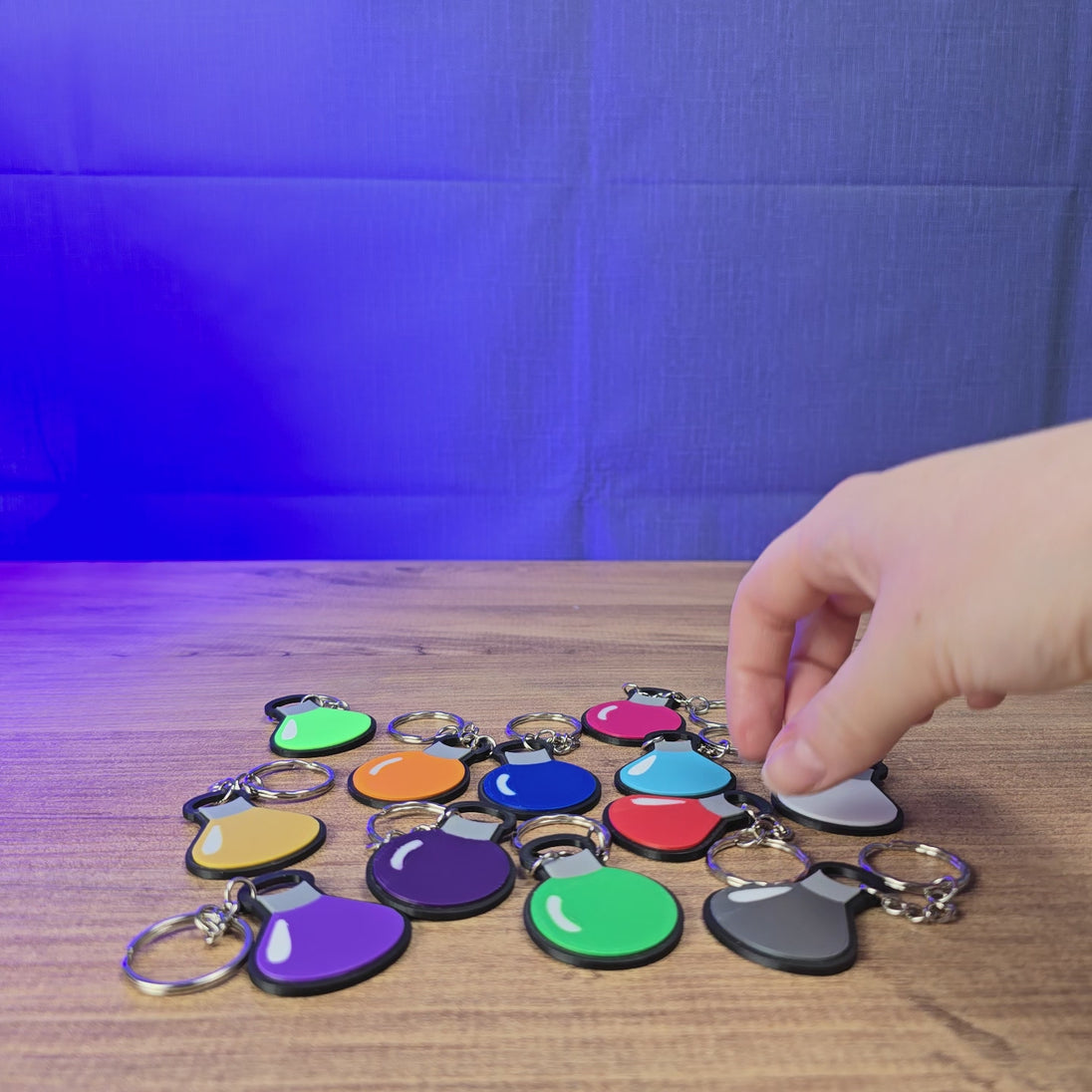 3D-printed Factorio flat flask keyring shown being held and rotated by hand, with a slim flask design and keychain loop.