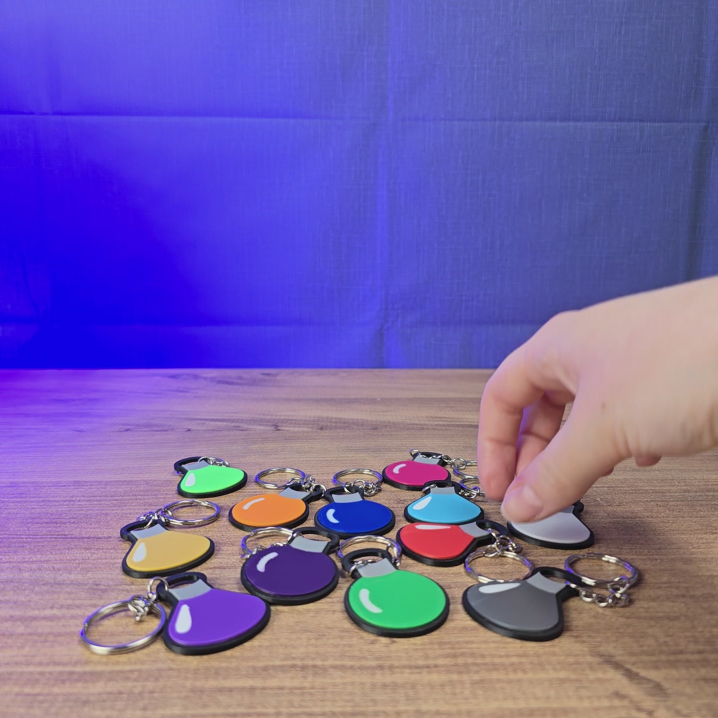 3D-printed Factorio flat flask keyring shown being held and rotated by hand, with a slim flask design and keychain loop.
