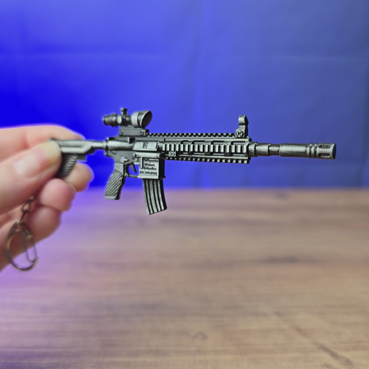 3D-printed HK 416A5 rifle keyring replica shown being held and rotated by hand, designed as a miniature rifle-inspired accessory or keychain.