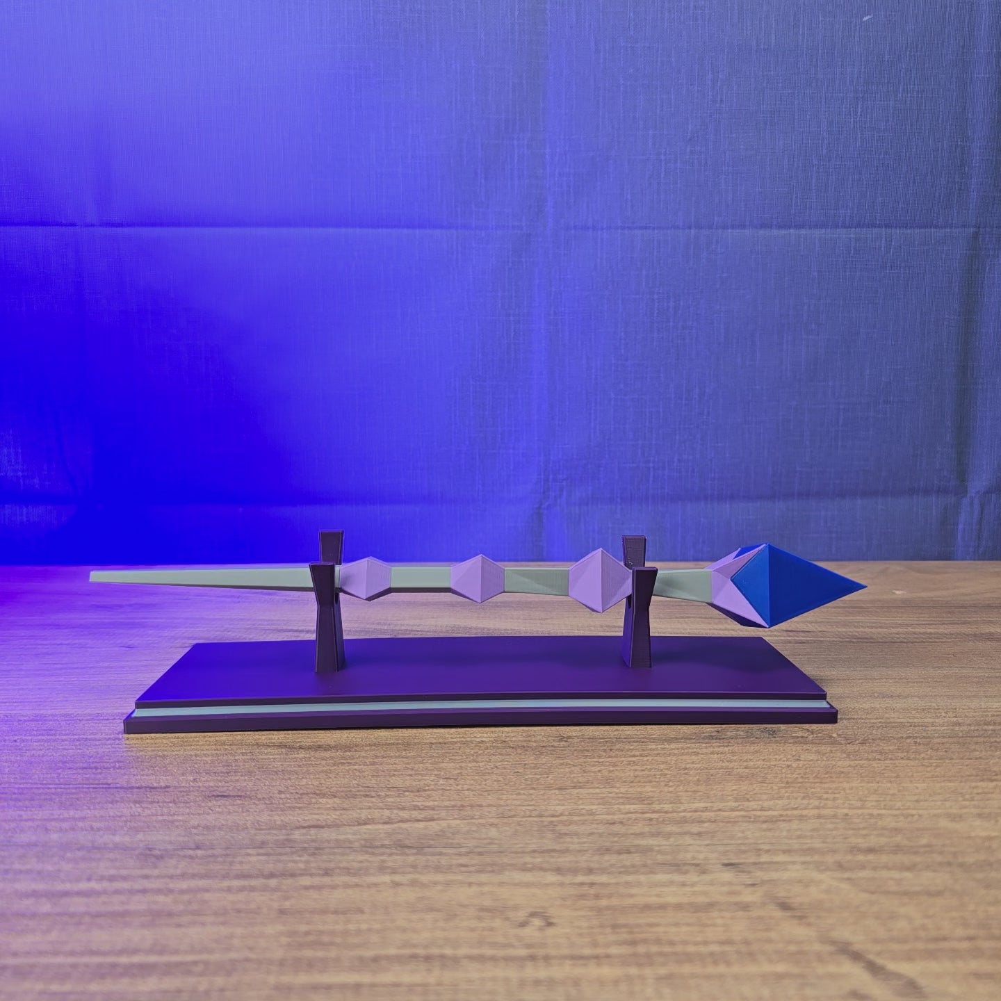 3D-printed RuneScape Kodai Wand replica shown being held and displayed with an optional stand and custom nameplate for Old School RuneScape fans.