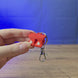 3D-printed Old School RuneScape Dragon Boots keyring shown being held and rotated by hand, designed as an OSRS-inspired accessory for fans and players.