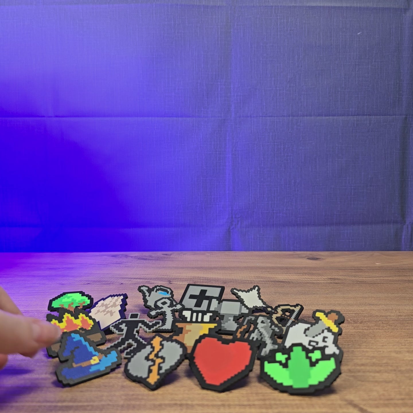 3D-printed Old School RuneScape skill pins shown being held and displayed, featuring multiple OSRS skill icon designs for fans, bags, lanyards, or display boards.