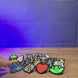 3D-printed Old School RuneScape skill pins shown being held and displayed, featuring multiple OSRS skill icon designs for fans, bags, lanyards, or display boards.