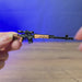 SVDS rifle metal keyring shown being held and rotated by hand, designed as a miniature rifle-inspired gamer accessory or keychain.