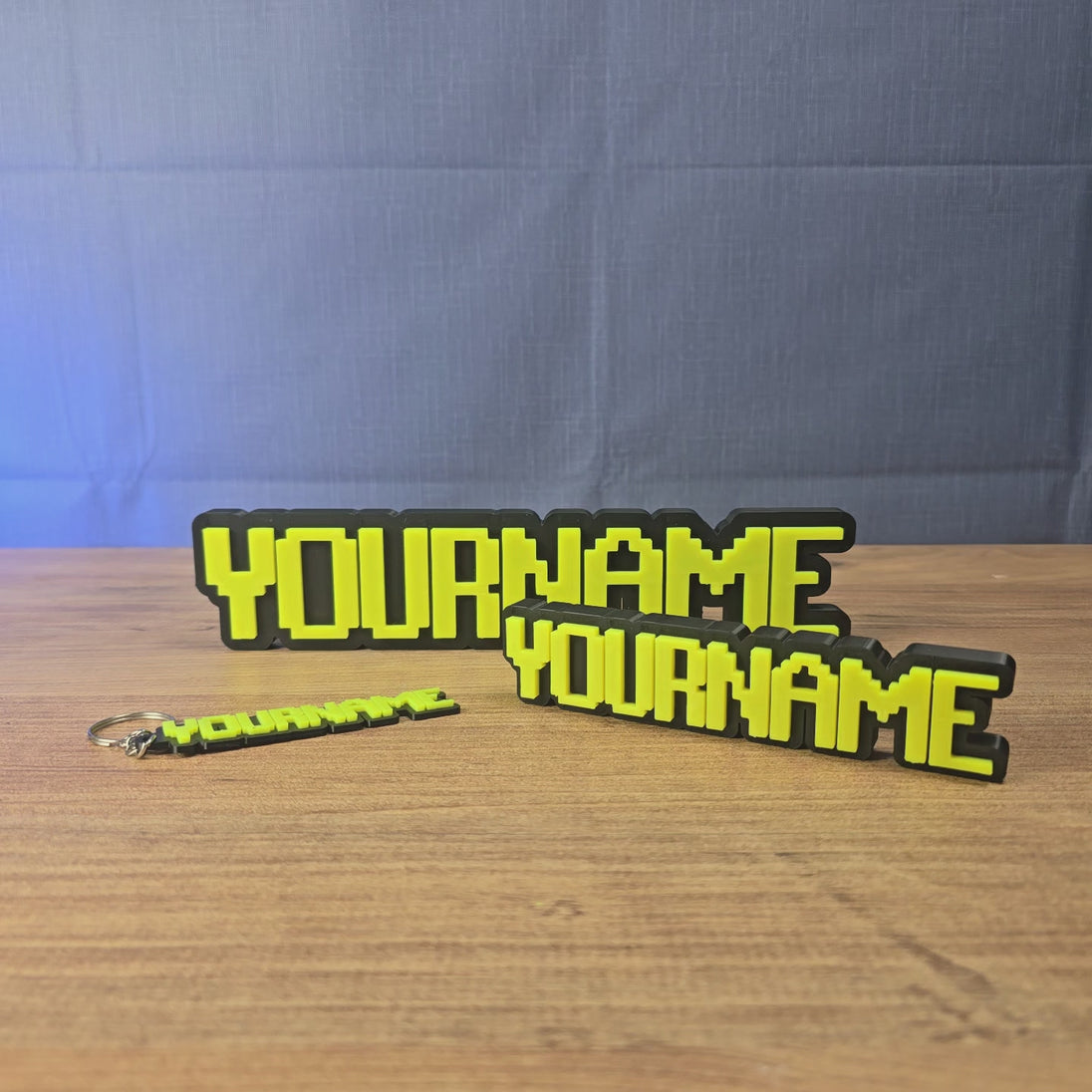 Personalised glow-in-the-dark RuneScape-style nameplate shown being held and displayed, featuring custom OSRS-inspired lettering for gaming desks, shelves, or display setups.