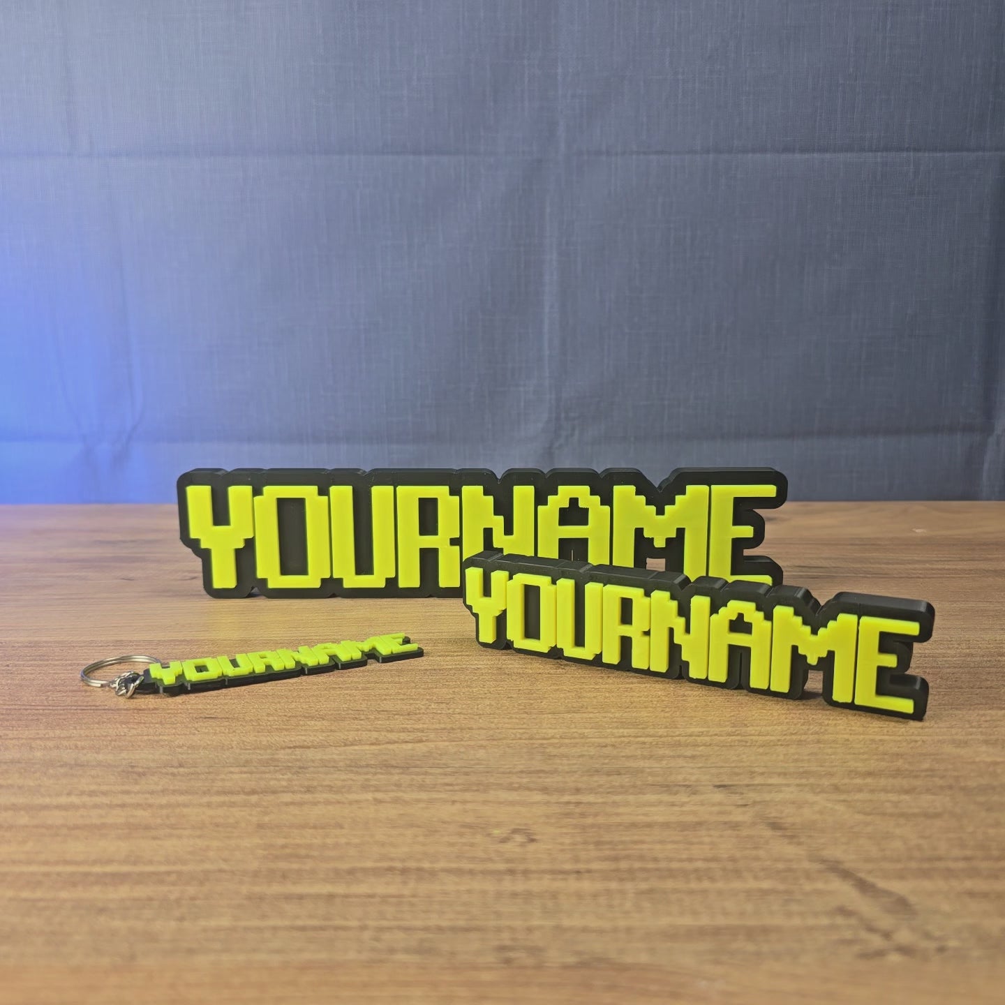 Personalised glow-in-the-dark RuneScape-style nameplate shown being held and displayed, featuring custom OSRS-inspired lettering for gaming desks, shelves, or display setups.