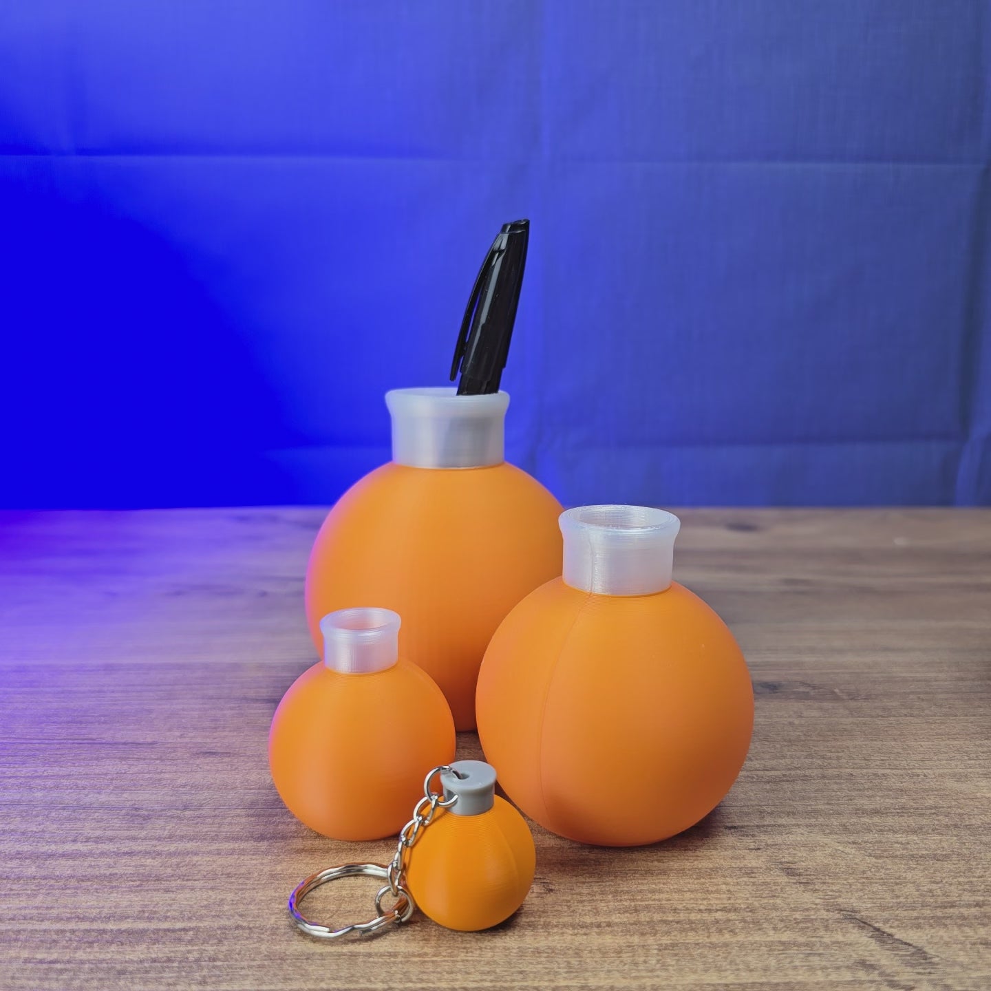3D-printed Factorio flasks in multiple sizes shown together, with matching game-inspired flask designs for display or desk accessories.