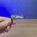 Chiappa Rhino mini revolver keyring shown being held and rotated by hand, designed as a miniature revolver-inspired accessory or keychain.