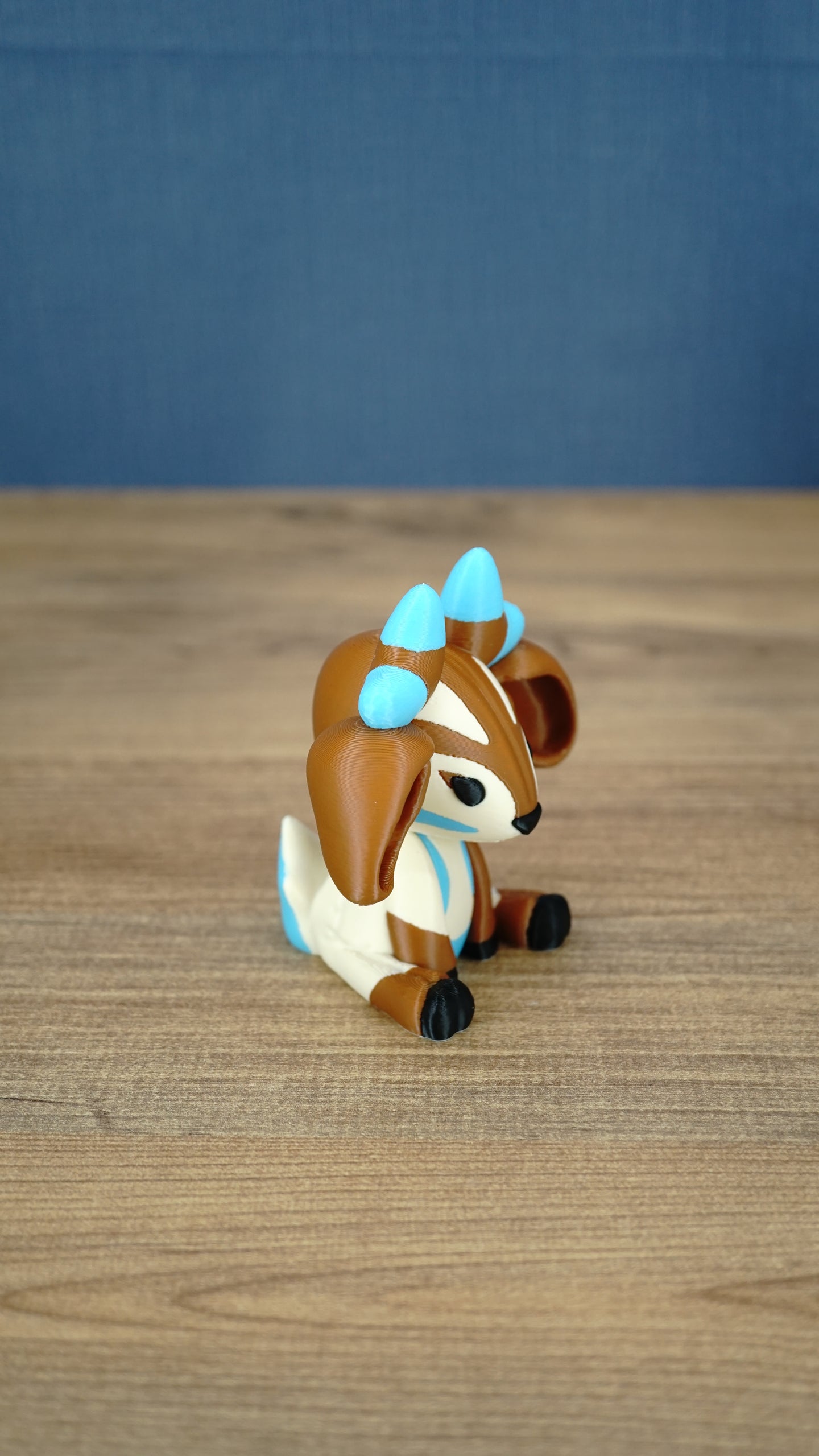Side view of the Proudhorned Sernuk-inspired plush figure showing cream body details and seated pose.