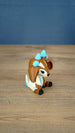 Side view of the Proudhorned Sernuk-inspired plush figure showing cream body details and seated pose.