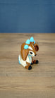 Side view of the Proudhorned Sernuk-inspired plush figure showing cream body details and seated pose.