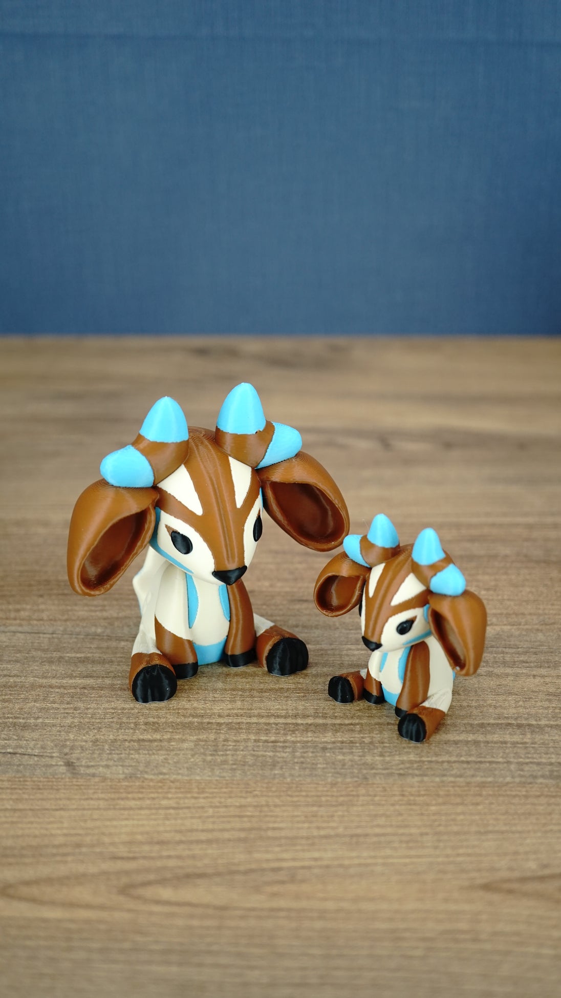 Proudhorned Sernuk-inspired Palia plush figure with cream and brown body, blue horn accents, and black hooves.