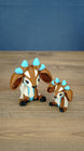 Proudhorned Sernuk-inspired Palia plush figure with cream and brown body, blue horn accents, and black hooves.