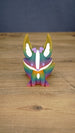 Front view of a rainbow Kitsuu figure with tall ears, white face markings, purple details, and a colorful gradient body.