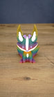 Front view of a rainbow Kitsuu figure with tall ears, white face markings, purple details, and a colorful gradient body.