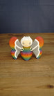 Front view of the Rainbow-Tipped Butterfly Plush figure with a rainbow body, grey and white wings, beige face and curved white antennae