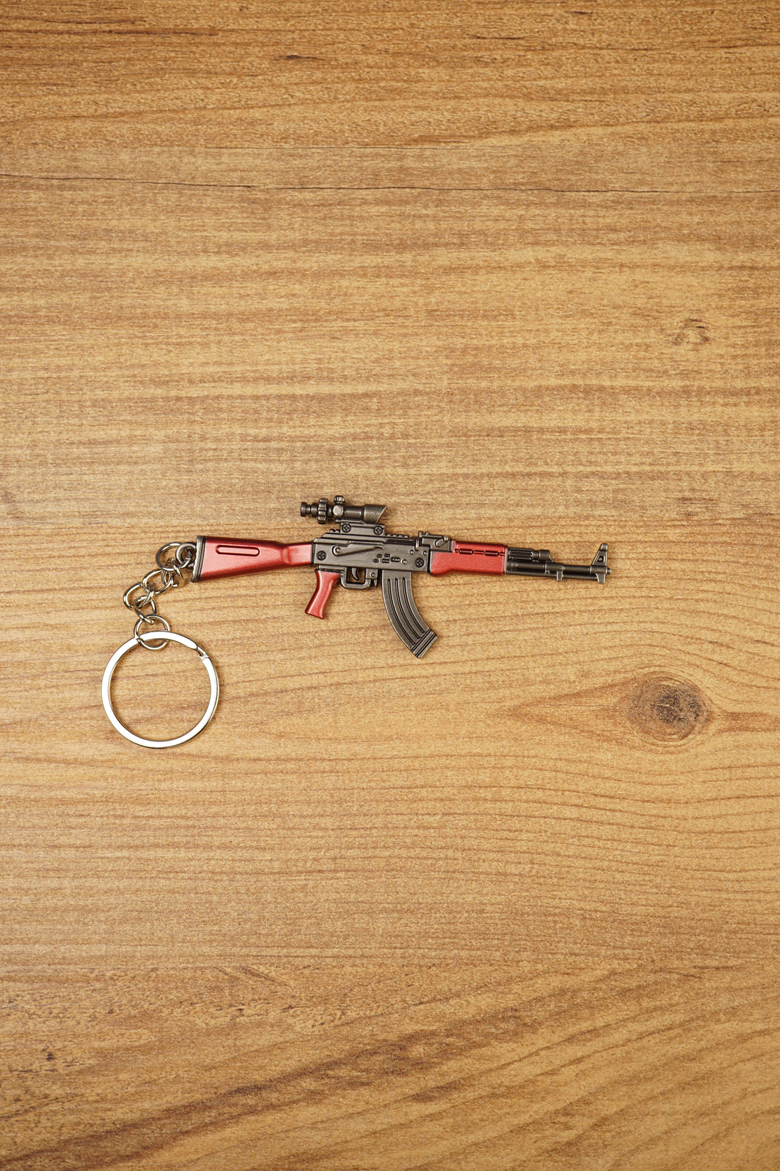 Red modded AKM-style rifle keychain with optic detail and metal keyring, designed as a tactical FPS gamer collectible accessory