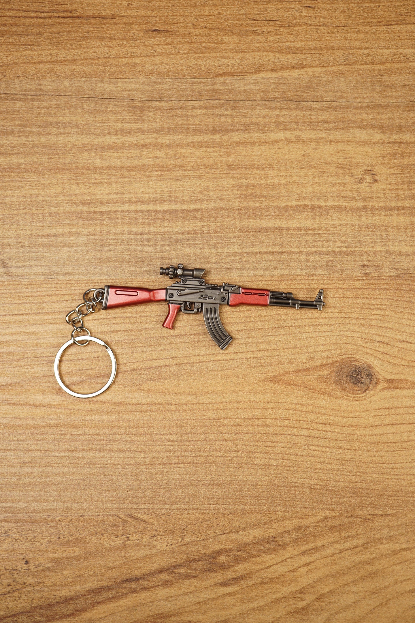 Red modded AKM-style rifle keychain with optic detail and metal keyring, designed as a tactical FPS gamer collectible accessory