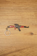 Red modded AKM-style rifle keychain with optic detail and metal keyring, designed as a tactical FPS gamer collectible accessory