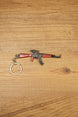 Red modded AKM-style rifle keychain with optic detail and metal keyring, designed as a tactical FPS gamer collectible accessory