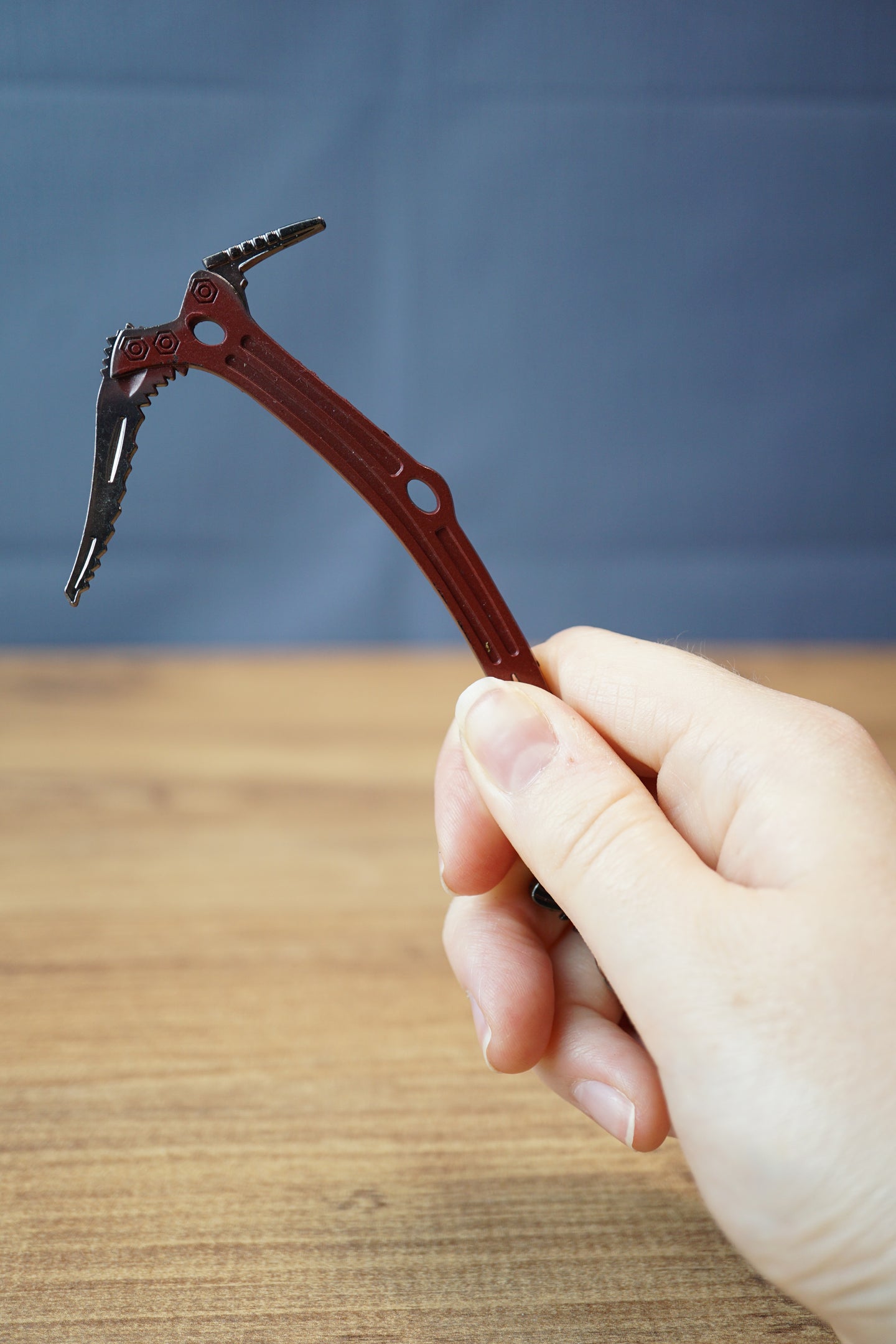 Red Rebel ice pick keyring replica held in hand with red handle, silver pick, black grip, and detailed miniature collectible design.