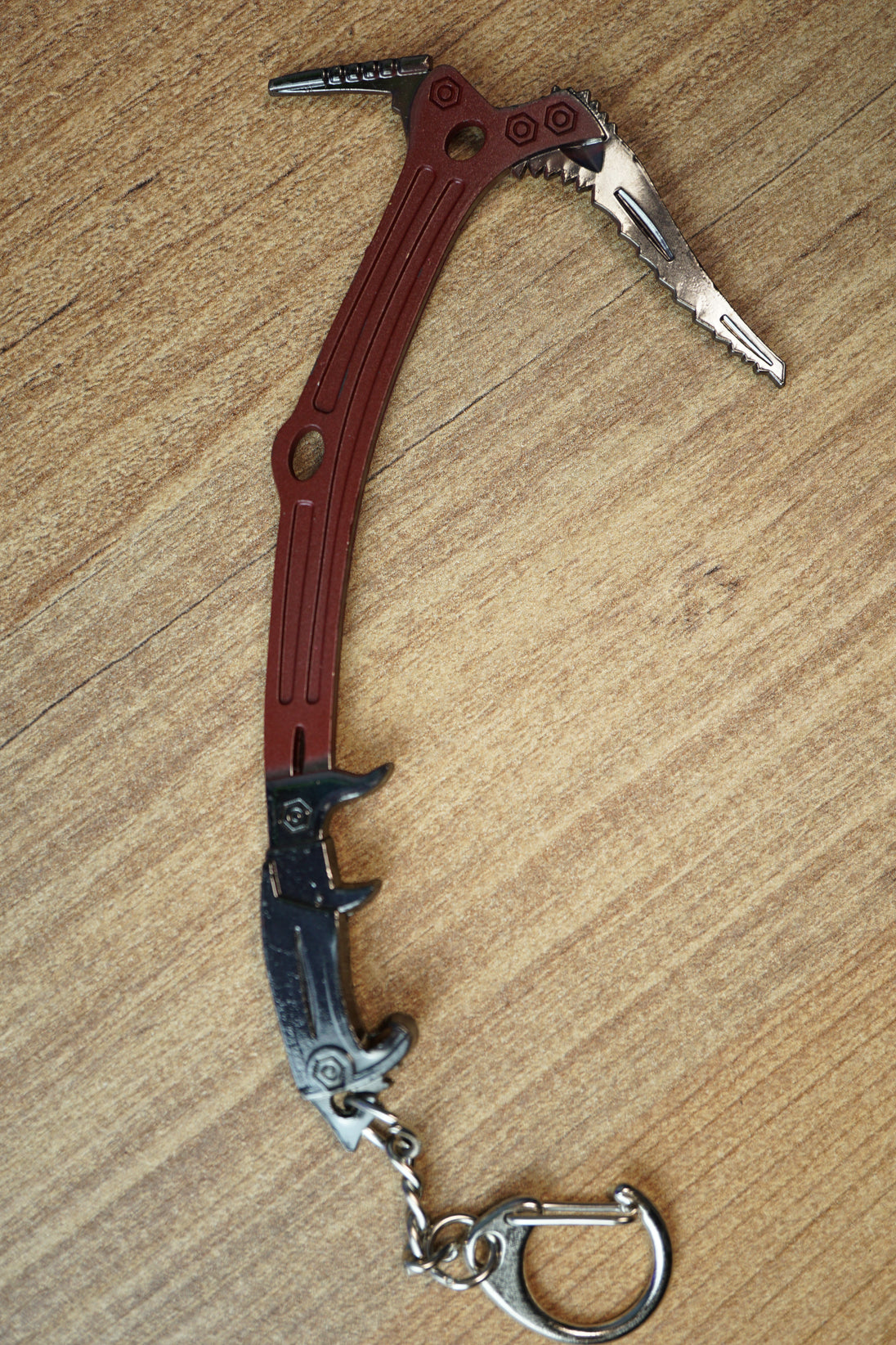 Red Rebel ice pick keyring replica shown from above with red handle, black grip, silver pick head, and compact keychain attachment.