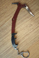Red Rebel ice pick keyring replica shown from above with red handle, black grip, silver pick head, and compact keychain attachment.