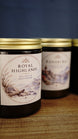 Royal Highlands soy wax candle in focus with sea salt and driftwood fragrance, with Bahari Bay candle softly blurred in the background.