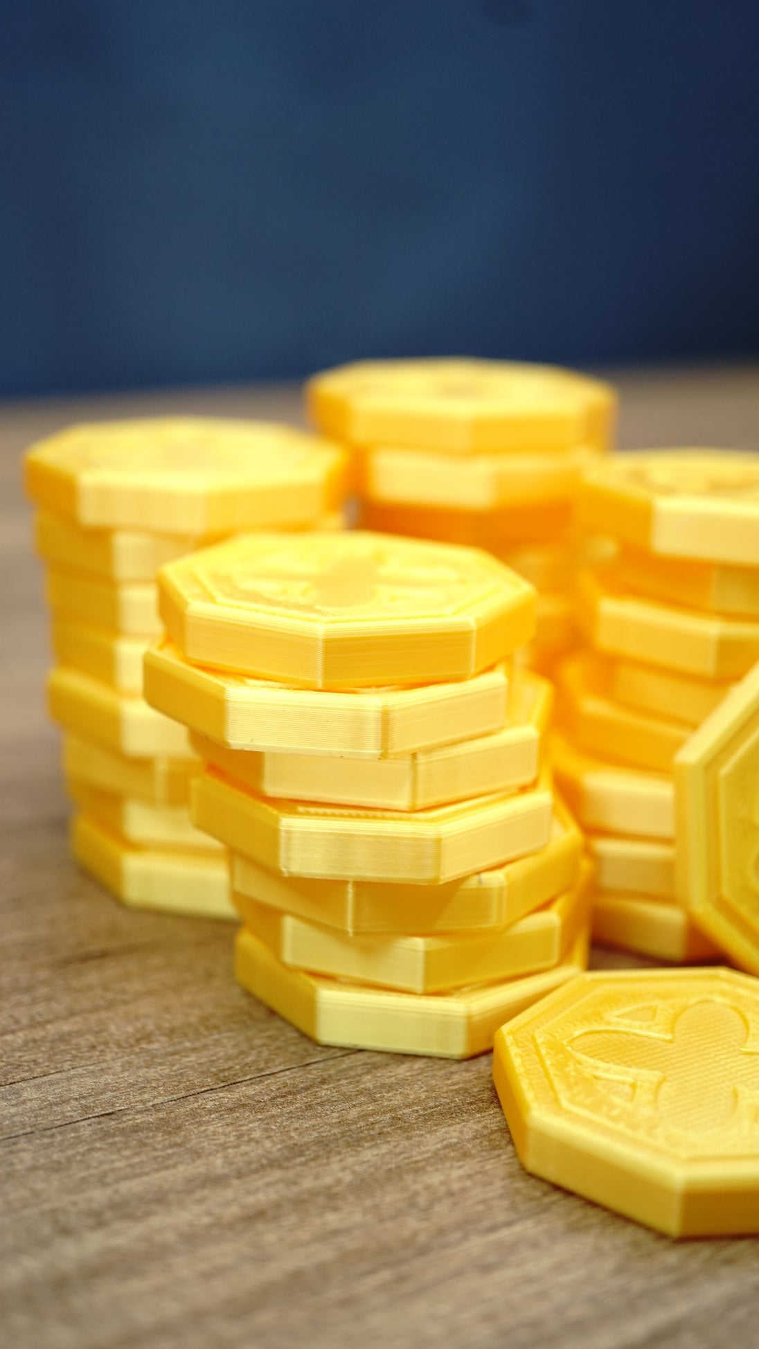 Close-up of a 4cm RuneScape inspired gold coin replica showing the detailed design and metallic-style gold silk finish for OSRS collectors
