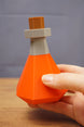 RuneScape potion bottle shown in hand size comparison OSRS prop