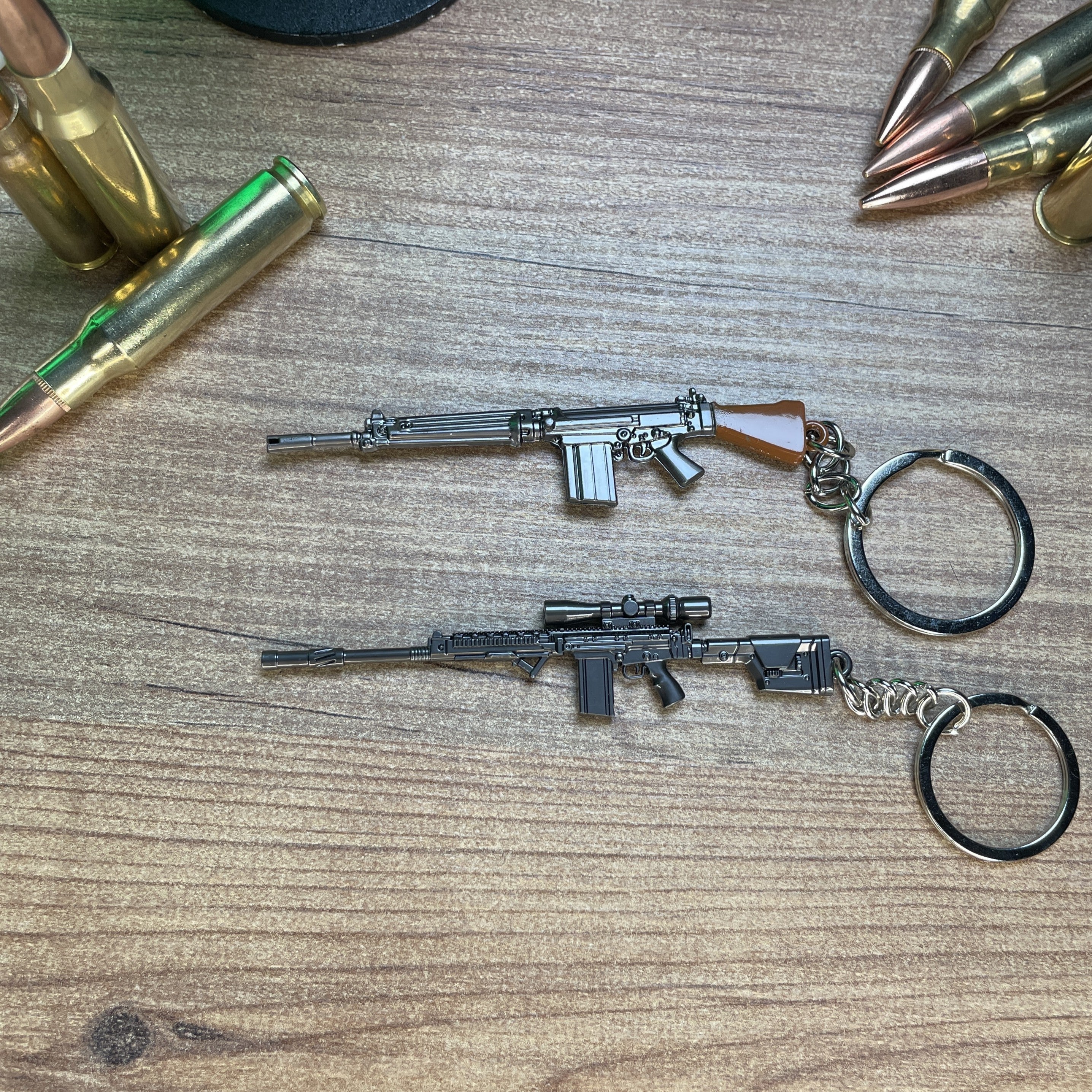 SA58 and FAL metal keychain replicas on display