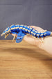 Full side view of the Shiver Leviathan figure held in hand, showing its 26cm length, articulated body, fins, and tail.