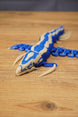 Close angled view of the Shiver Leviathan figure showing the detailed head, curved claws, blue body, and bone colour markings.