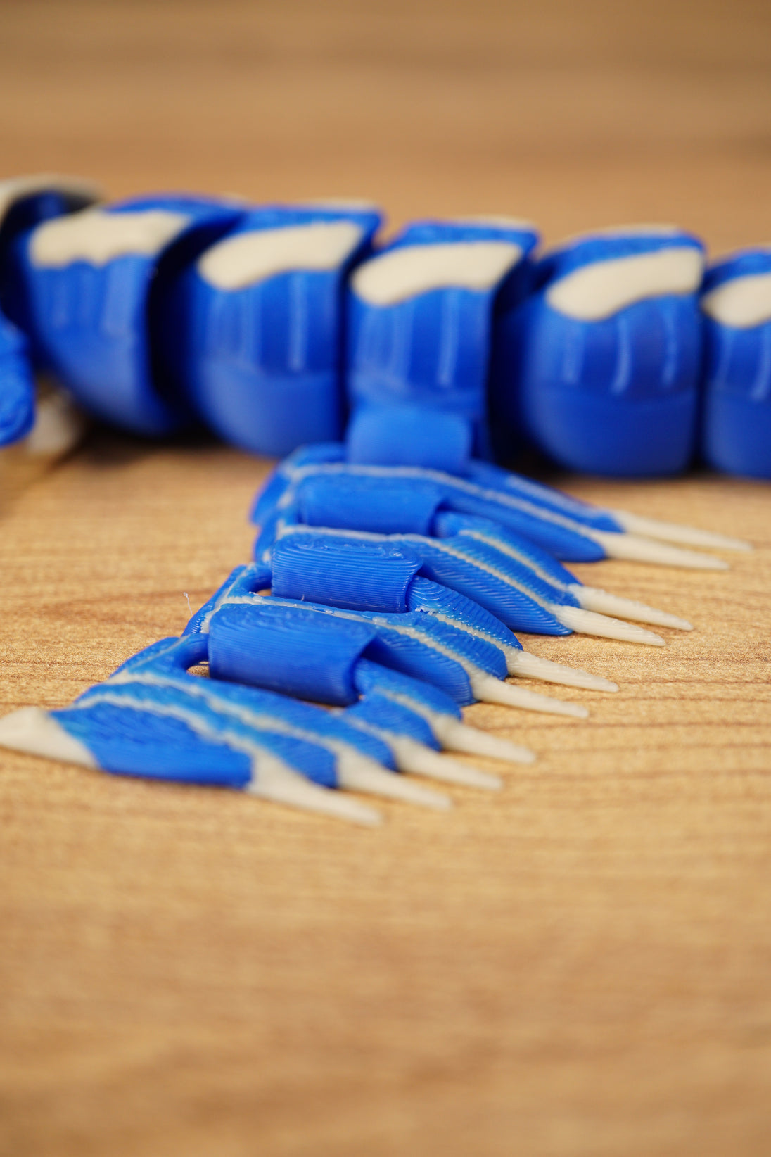 Detailed close-up of the Shiver Leviathan fin section with blue articulated panels, bone spikes, and segmented body behind.