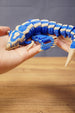 Flexible Shiver Leviathan figure curved in hand, highlighting the blue body, bone markings, fins, and poseable segmented design