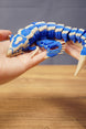 Flexible Shiver Leviathan figure curved in hand, highlighting the blue body, bone markings, fins, and poseable segmented design