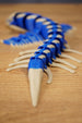 Rear view of the Shiver Leviathan figure showing the tapered bone tail, blue segmented body, and side fin details.
