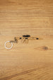 Tan SIG MCX-SPEAR style rifle keychain with black scope and metal keyring laid flat on a wooden surface for tactical FPS fans