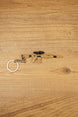 Tan SIG MCX-SPEAR style rifle keychain with black scope and metal keyring laid flat on a wooden surface for tactical FPS fans