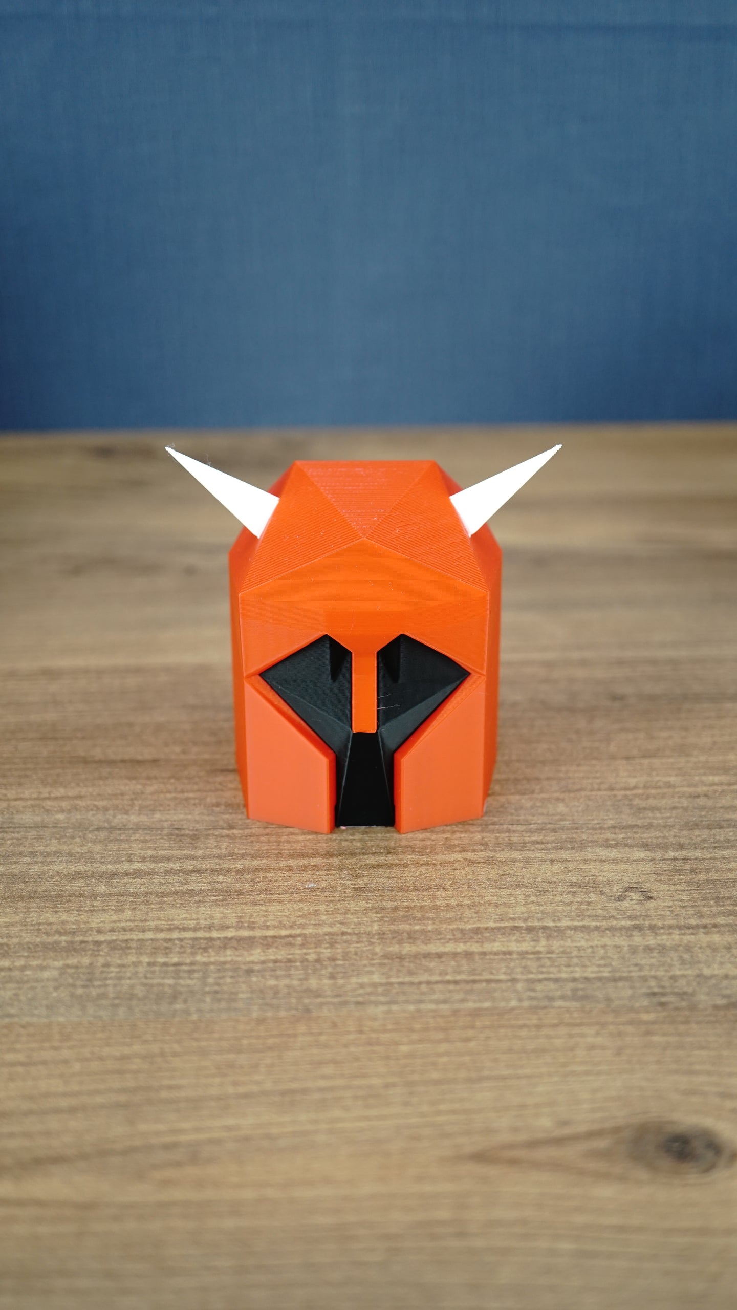 Front view of the small Dragon Med Helm collectible replica with classic red, black and white colours for RuneScape fans