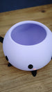 Close-up top view of a purple Stardew Valley Junimo planter pot showing the open hollow interior for plants or storage.