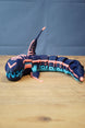 Full side view of articulated Marrowbreach inspired figure with segmented body, tall dorsal fin, dark blue shell and bright light blue underside.